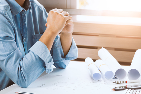 Close-up of confident architect female in casual wear working on desk. Concept building on project.の写真素材