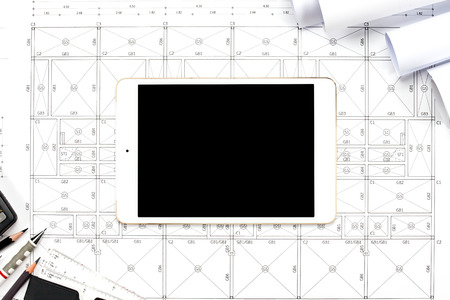 Digital tablet with drawings tools on abstract engineering drawings background.の写真素材