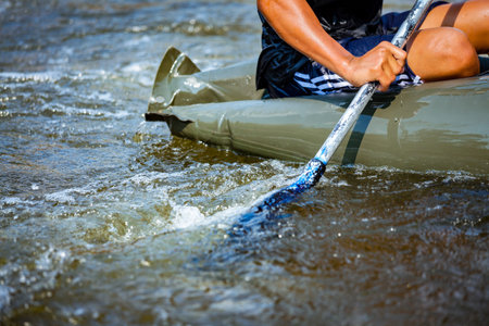 Close-up hand of young person is rafting on the river, extreme and fun sport at tourist attraction