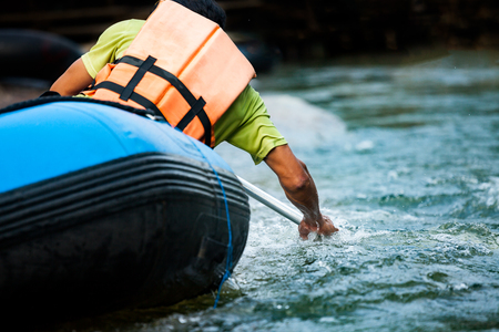 Close-up of young person rafting on the river, extreme and fun sport at tourist attractionの写真素材
