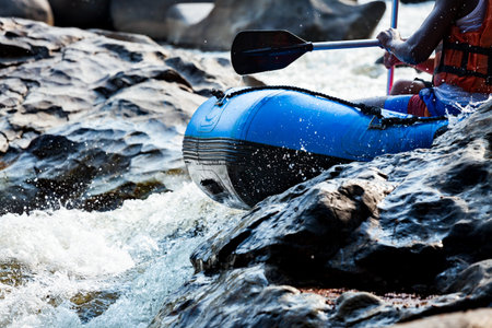 Close-up of young person rafting on the river, extreme and fun sport at tourist attraction