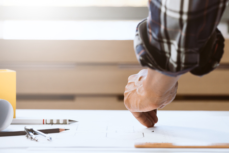 Part of engineer male working in workspace. Concept of builder working on house project.の写真素材