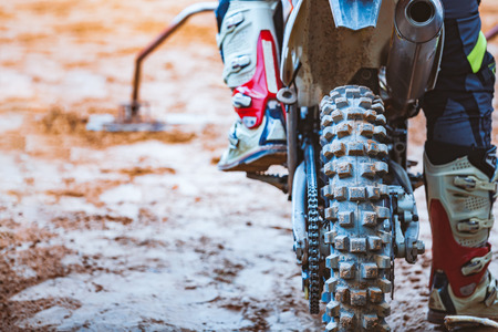 Close-up of biker sitting on motorcycle in starting point before the start of the raceの写真素材