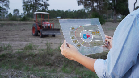 Asian female farmer using portable tablet computer to inspect the agricultural engine in farmland....