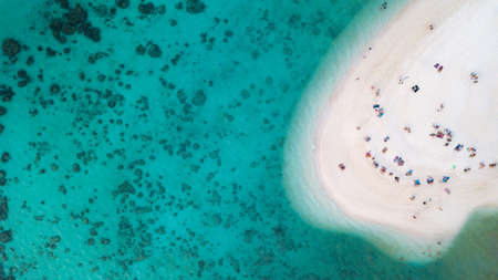 Aerial view or top view of beautiful curve beach with traveller relaxing with the emerald sea at Koh Lipe island in Satun, Thailand. Space for text. - Imageの写真素材