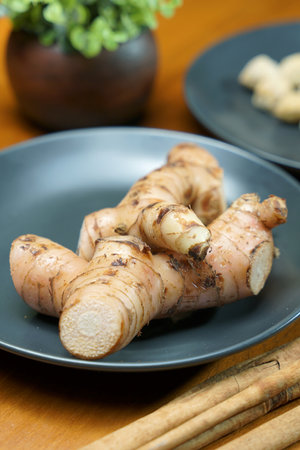 Horseradish root in a plate on a wooden table.の写真素材
