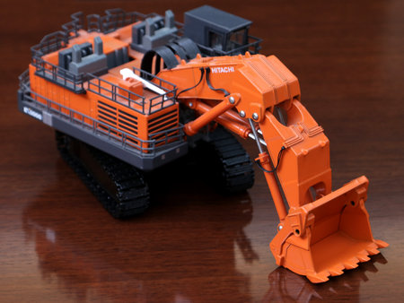 Toy excavator on a wooden table, close-up. Toy constructionのeditorial素材