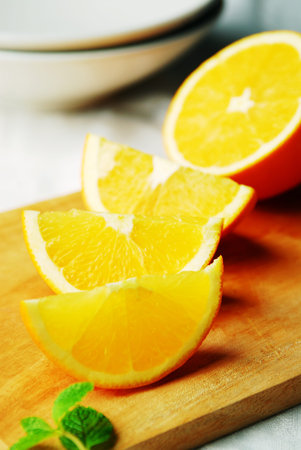 Fresh orange slices on a cutting board. Shallow dof.