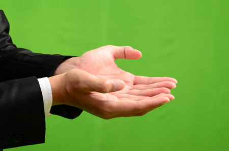Businessman hands showing something on green screen background, close-upの写真素材