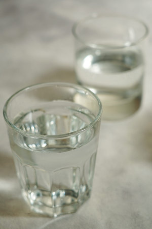 Two glasses of water on a light background. Selective focus.の写真素材