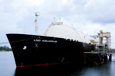 LNG Tanker loading gas in LNG terminal in Industrial harbor, Indonesia