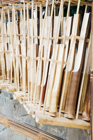 Wooden bamboo sticks on a shelf in a market, Thailand.の写真素材