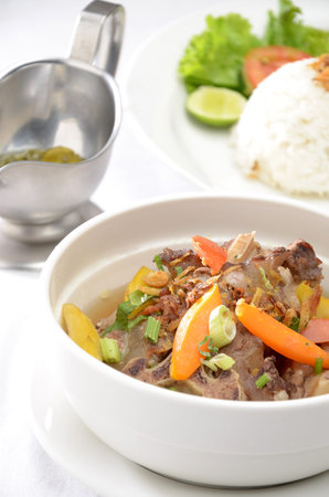 Thai style beef stewed with vegetables and rice on white backgroundの写真素材