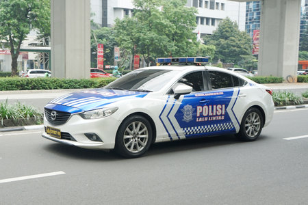 Indonesian police car Mazda 6 on the road at commercial and business distric Rasuna Said Street, Jakarta, Indonesiaのeditorial素材