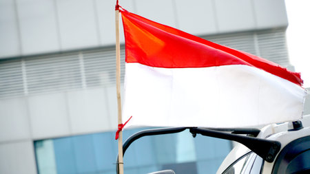 Indonesian flag on the car. Selective focus. Shallow depth of field.
