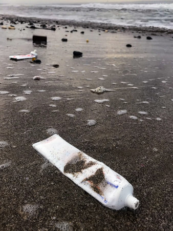 Bali, Indonesia - July 11, 2020 : Toothpaste tubes plastic waste on beach