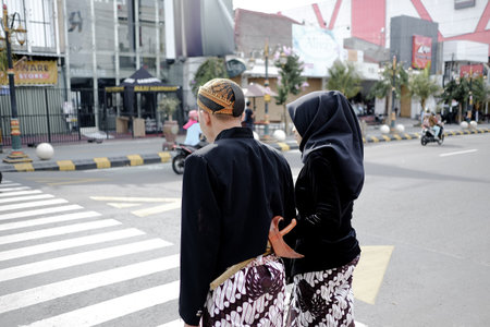 Madiun, East Java, Indonesia on Dec 29, 2020. Stepping halfway. A pair of humans immortalize the...