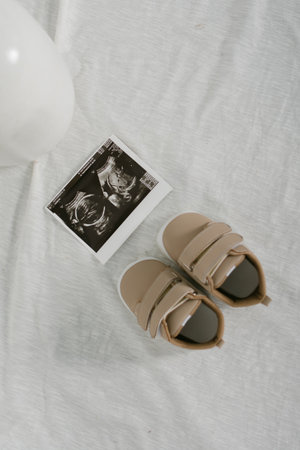 Ultrasound picture of baby's first trimester with shoesの写真素材
