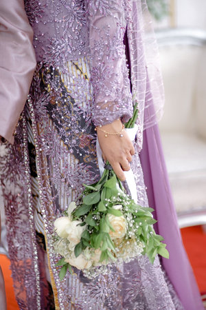 Bride holding a wedding bouquet of flowers in her hand at the wedding ceremonyの写真素材