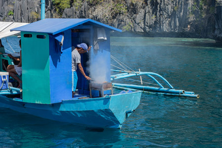 MAN COOKING ON BOAT FROM PHILIPPINES, PALAWAN, 2019のeditorial素材