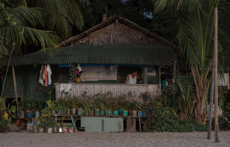 Rustic house on beach and palms background, philippines, port bartonのeditorial素材
