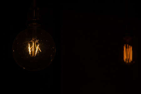 Vintage worm lamp lighting and black background photographyの写真素材