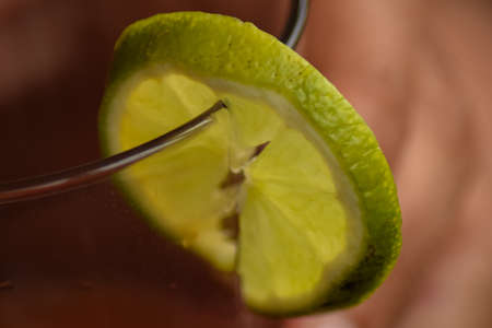 Piece of lemon in a drink glass backgroundの写真素材