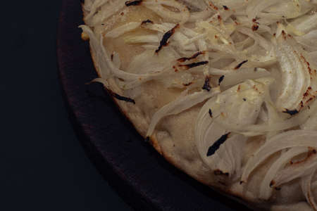 Home made onion italian Pizza with cheese and vegetables on black backgroundの写真素材