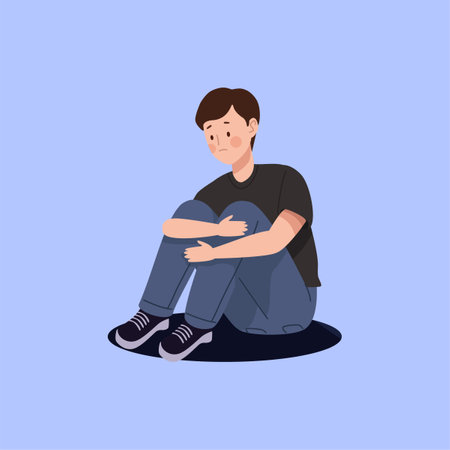 Sad young man sitting on the floor. Vector illustration in flat styleのイラスト素材
