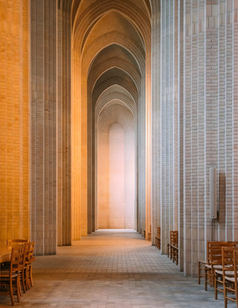 Interior view of Grundtvig's Church featuring its distinctive brick architecture, arches, and rows...