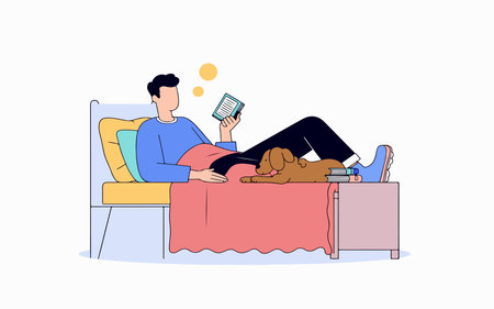 A man relaxes in bed reading a book with his dog lying beside him on a stack of books on the nightstand.のイラスト素材