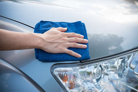 Worker cleaning  car with microfiber cloth, car detailing selective focus concept.の写真素材