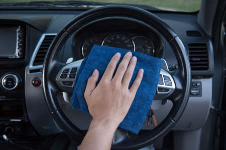 Worker cleaning  car with microfiber cloth, car detailing selective focus concept.の写真素材