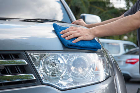 Worker cleaning  car with microfiber cloth, car detailing selective focus concept.の写真素材