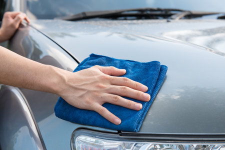Worker cleaning  car with microfiber cloth, car detailing selective focus concept.の写真素材