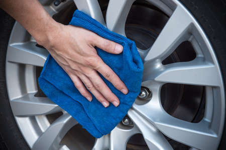 Worker cleaning  car with microfiber cloth, car detailing selective focus concept.の写真素材