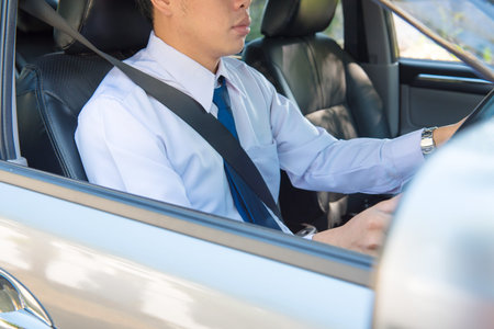Close up portrait of  male driving car from rear view ,vintage filter,sits on driver`s seat, enjoys...