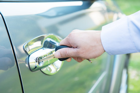 Close up of a male hand opening a car door,businessman getting out of car