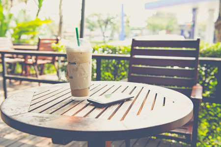 Cold iced coffee on wooden table in the coffee shopの写真素材