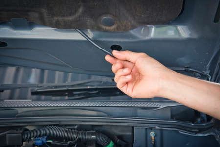 A man checking the auto engine,  uses a wrench to fix the car engine,repair serviceの写真素材