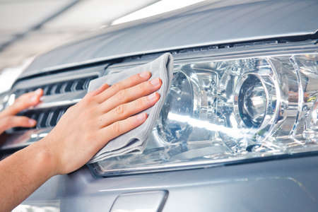 Worker cleaning  car with microfiber cloth, car detailing selective focus concept.の写真素材