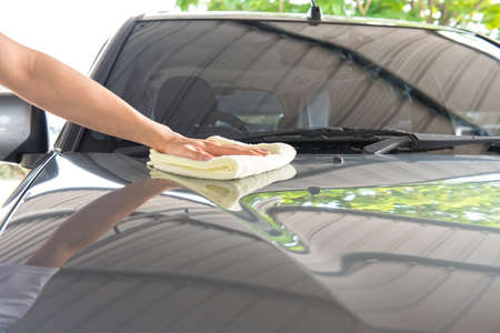 Worker cleaning  car with microfiber cloth, car detailing selective focus concept.の写真素材