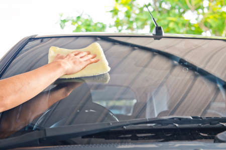 Worker cleaning  car with microfiber cloth, car detailing selective focus concept.の写真素材