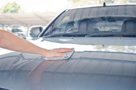Worker cleaning  car with microfiber cloth, car detailing selective focus concept.の写真素材