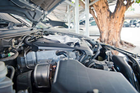 A man checking the auto engine,  uses a wrench to fix the car engine,repair service.の写真素材