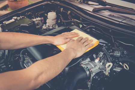 Hand with microfiber cloth cleaning interior car,cleaning car interior - car detailing and valeting conceptの写真素材