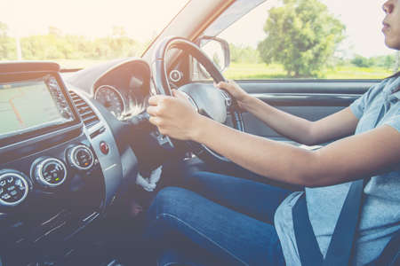 Close up portrait of  male driving car from rear view ,vintage filter,sits on driver`s seat, enjoys music,transport concept.の写真素材