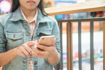 Woman sending message on smartphone ,touching smartphone screenの写真素材