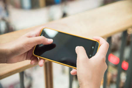 Woman touching smartphone screen for surfing the internet,enjoy to travel without bordersの写真素材