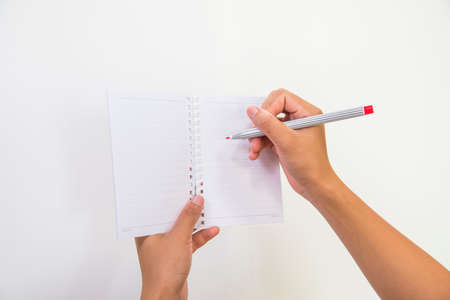 Woman hand with pen on a white backgroundの写真素材